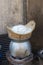 Sticky rice is streaming in bamboo basket steamer on stainless pot with charcoal