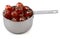 Sticky whole glace cherries in a cup measure
