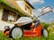 Stihl lawn mower operated with li-ion batteries house background