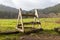 A stile over a fence in farm field