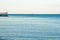 Still clear blue sea and sky background view