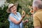 Still so incredibly charming. an elderly couple tending to plants in their backyard.