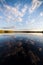 Still lake perfect reflection of sky and clouds