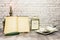 Still life of antique books with candles and tea set, a clock is incorporated