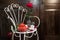 Still life with antique chair, flowers and tea