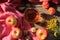 Still life with apples, glass cup of tea, walnuts, cones, and autumn flowers on the table.