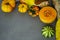 Still life with autumn vegetables and fruits on wooden background. Pumpkins, butternut, garlic, bow