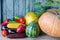 Still life of autumn vegetables: melon and watermelon, corn, eggplant, peppers, tomatoes