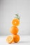 Still life balance of oranges and a branch of fir. The concept of winter, New Year and Christmas. Copy space.