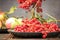 Still life berries of a viburnum and garden seasonal apples in p