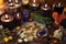Still life with black candles, runes, crystals and four leaf clover on witch table