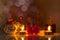 Still life, bottles of aromatic oils with candles, flowers, towel on glossy table