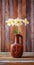 Still life of a bouquet of daffodils flowers in an old ceramic jug on a wooden vintage grunge background