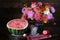 Still life with a bouquet and watermelon. asters, dahlias and different autumn flowers