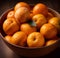 A still life of a bowl filled with a variety of orange fruits, each with unique textures