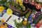 Still life with bowl of herbs, candles and old book on witch table