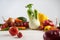 Still life of a bunch fresh different seasonal green vegetables avocado, fennel, garlic, onion, tomato, red yellow pepper.