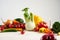 Still life of a bunch fresh different seasonal green vegetables avocado, fennel, garlic, onion, tomato, red yellow pepper.