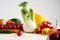 Still life of a bunch fresh different seasonal green vegetables avocado, fennel, garlic, onion, tomato, red yellow pepper.