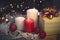 Still life with burning candles, Christmas decorations and a gift box