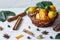 Still life with calamondines in basket, cinnamon sticks, anise star, cardamom, ginger