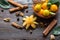 Still life with calamondines in basket, cinnamon sticks, anise star, cardamom, ginger. side view