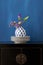 Still life with a Chinese cabinet and flowers in a little vase