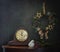 Still life with a Christmas wreath, old clocks, and a white porcelain bird