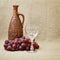 Still-life - clay bottle, grapes and a glass