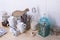 Still life of coffee cups and utensil on a wooden bar counter. White background, copy space.