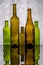 Still life with colored bottles on a reflective surface