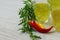 Still life with colorful bright cocktails on wooden background, chilli pepper and rosemary near