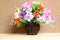 Still life with colourful flower bunch in wood vase on wooden table