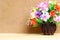 Still life with colourful flower bunch in wood vase on wooden table and copy space