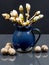 Still life composition with chestnut buds in a blue ceramic pot and walnuts