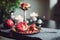 Still life composition with juicy red cut cleared pomegranate on a copper plate, burning candles and other oriental decor on the
