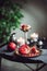 Still life composition with juicy red cut cleared pomegranate on a copper plate, burning candles and other oriental decor on the