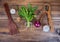 Still life in country style on a background of old wood. Arrangement of green rocket leaves tied with string, garlic