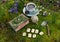 Still life with crafted witch diary, tea set, runes and crystals in the garden