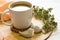 Still life with a cup of coffee and flowers on a light cream color wooden table with two ceramic birds. Sweet cozy home