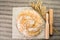 Still life with delicious baked good, wheat and wooden pestles o