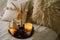 Still life details in home interior of living room. Pumpkin and cup of tea with candles on a serving tray.