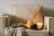 Still life details in home interior of living room. Pumpkin and cup of tea with candles on a serving tray. Rest and Reading