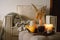 Still life details in home interior of living room. Pumpkin and cup of tea with candles on a serving tray. Rest and Reading