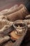 Still life details of living room. A candle tied a warming scarf on the rustic wooden tray, candle and warm woolen socks