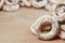 Still life of donut glaze on a wooden surface. Glazed bagels are a small bunch on a wooden table. Flour sweets to the Tea Part