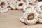 Still life of donut glaze on a wooden surface. Glazed bagels are a small bunch on a wooden table. Flour sweets to the Tea Part