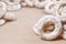 Still life of donut glaze on a wooden surface. Glazed bagels are a small bunch on a wooden table. Flour sweets to the Tea Part