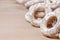 Still life of donut glaze on a wooden surface. Glazed bagels are a small bunch on a wooden table. Flour sweets to the Tea Part