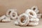 Still life of donut glaze on a wooden surface. Glazed bagels are a small bunch on a wooden table. Flour sweets to the Tea Part